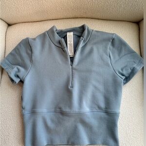 ALO Yoga Cropped Half-Zip Top in Dusty Blue it has good stretch I’m usually an s
